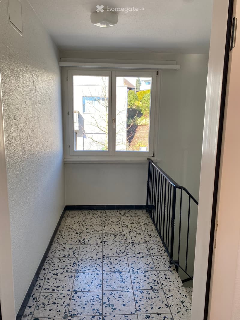 Empty room, tile floor, open window, black railings