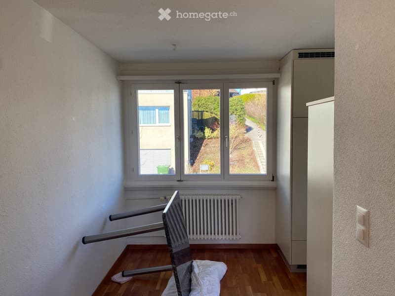empty room, large window, radiator, wooden floor, leaning chair