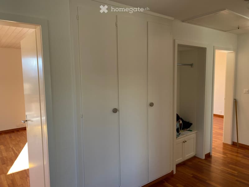 Empty room, white walls, white floor, tall white wardrobe, small wardrobe, wooden floor