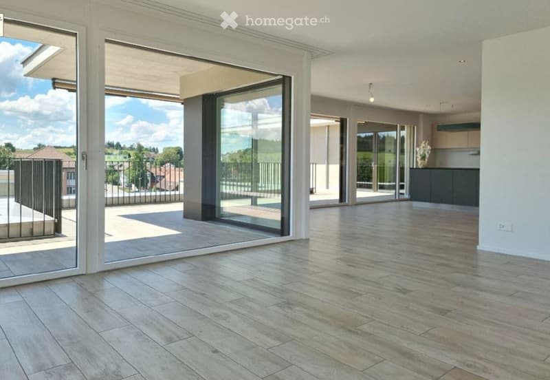 Floor-to-ceiling windows, balcony, white walls, wooden floors, large open space