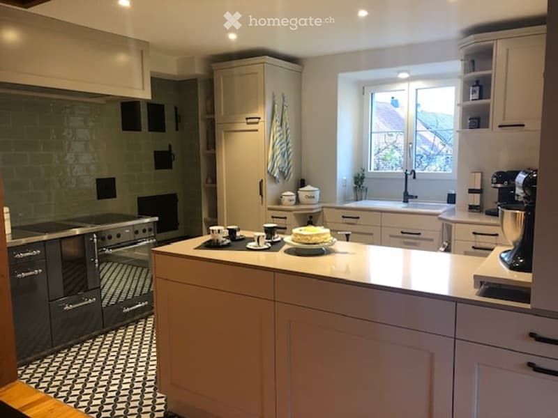 Modern kitchen, gas stove, oven, refrigerator, dishwasher, washing machine, ceramic tiled floor, white cabinets, wooden floor, white walls, window, countertop