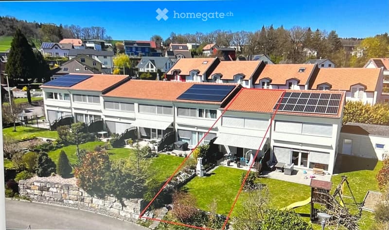 Apartments with solar panels, garden, playground, green hills in the background