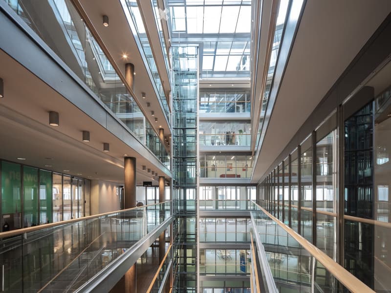 Multi-story building with glass walls, metal frames, glass floors, metal railings, lighting on the ceiling