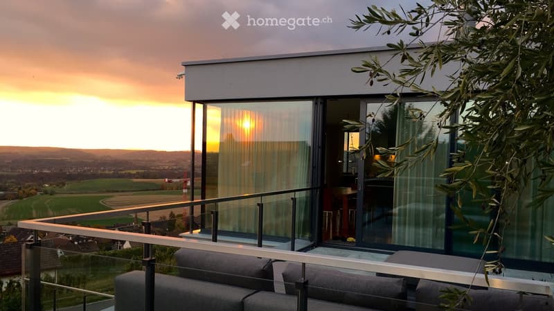 Outdoor sofa set, glass railings, glass sliding doors, panoramic view, sunset