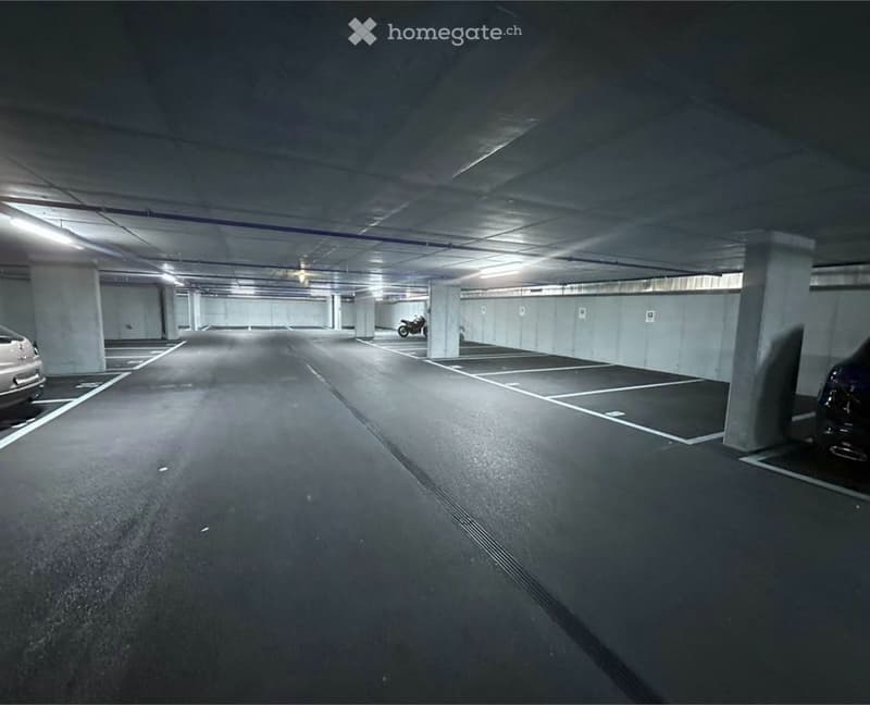 Underground parking with a motorcycle parked.