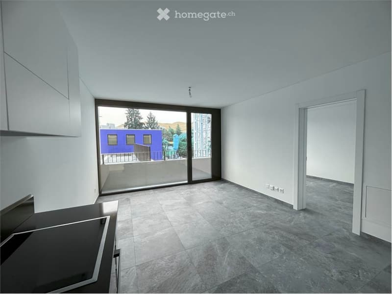 empty room, white walls, gray tiles, sliding glass door to balcony, modern kitchen set