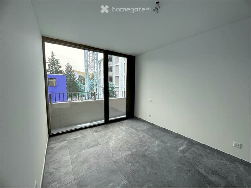 empty room, tiled floor, sliding glass doors leading to a balcony, white walls, power outlets, white ceiling