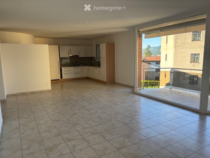 empty room, tiled floor, sliding glass door, kitchen with cabinets and appliances