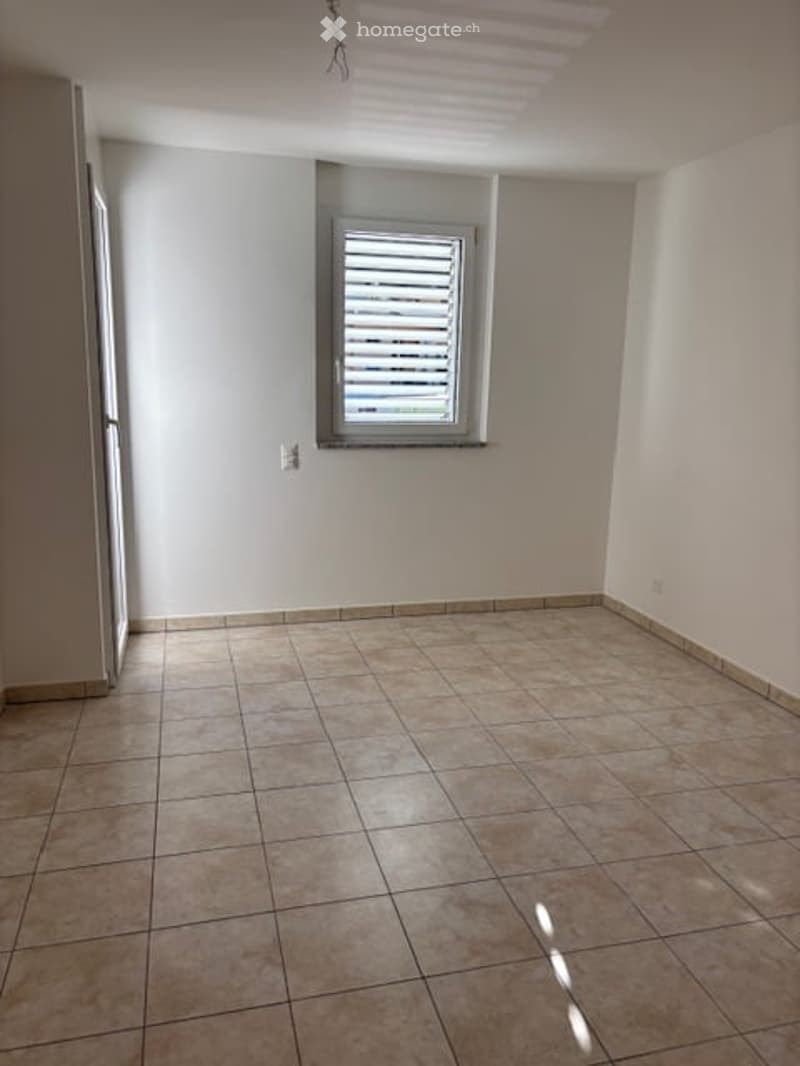 empty room, tiled floor, white walls, window with blinds, power outlet