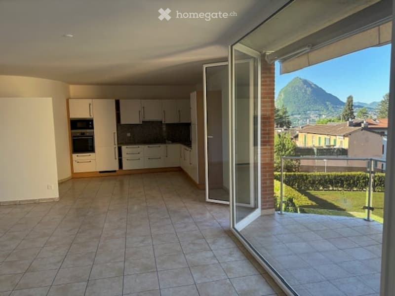 Open space with kitchen, balcony, tiled floor, white cabinets, oven, microwave, large windows