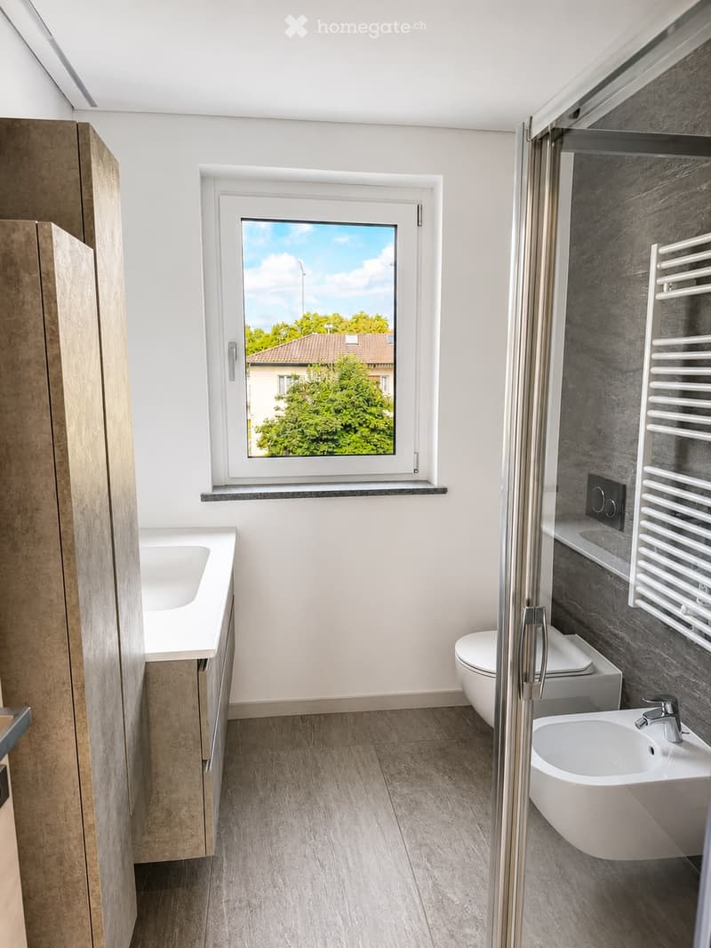 Modern bathroom with a large window, sink, toilet, bathtub, and radiator.
