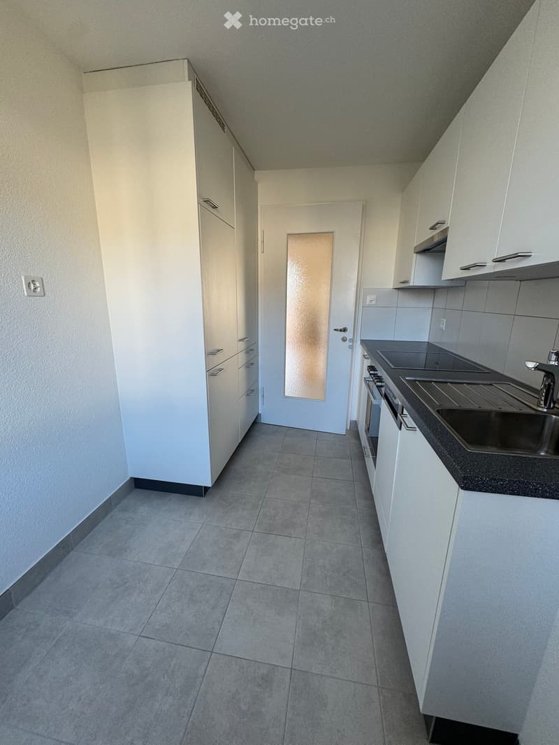 modern kitchen with white cabinetry, tile flooring, modern sink, gas stove, dishwasher
