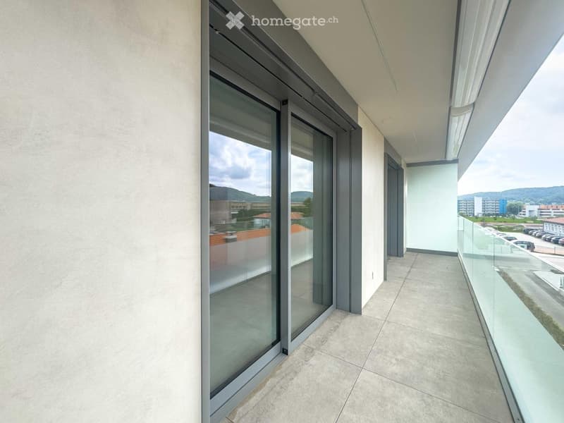 large balcony, glass sliding doors, view of surrounding area