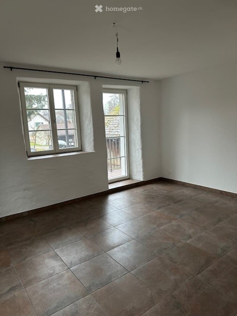 Empty room, brown tiles, windows, glass door, bare walls