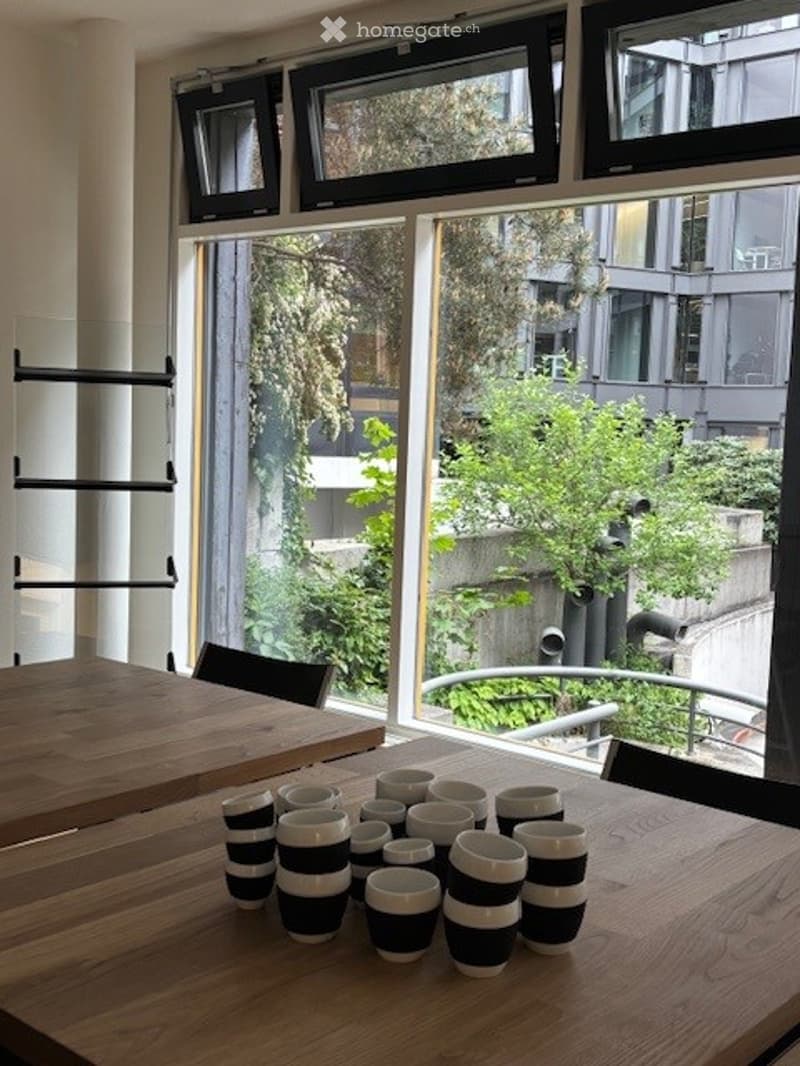 modern dining table, black and white striped mugs, window with view of outdoor