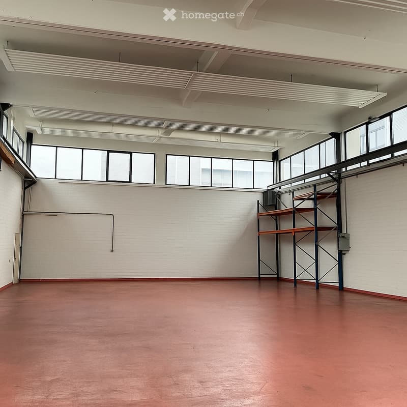 Empty room, white walls, red floor, large windows, metal shelving unit
