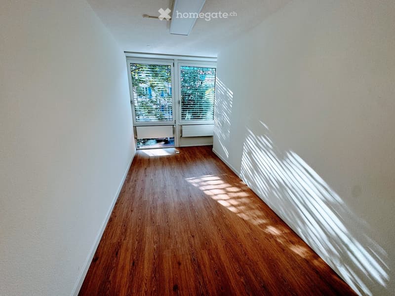 empty room, wooden floors, sliding glass door leading to a balcony, white walls