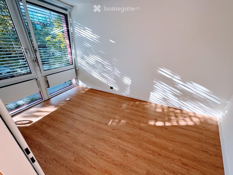 Hardwood floors, white walls, large windows, balcony