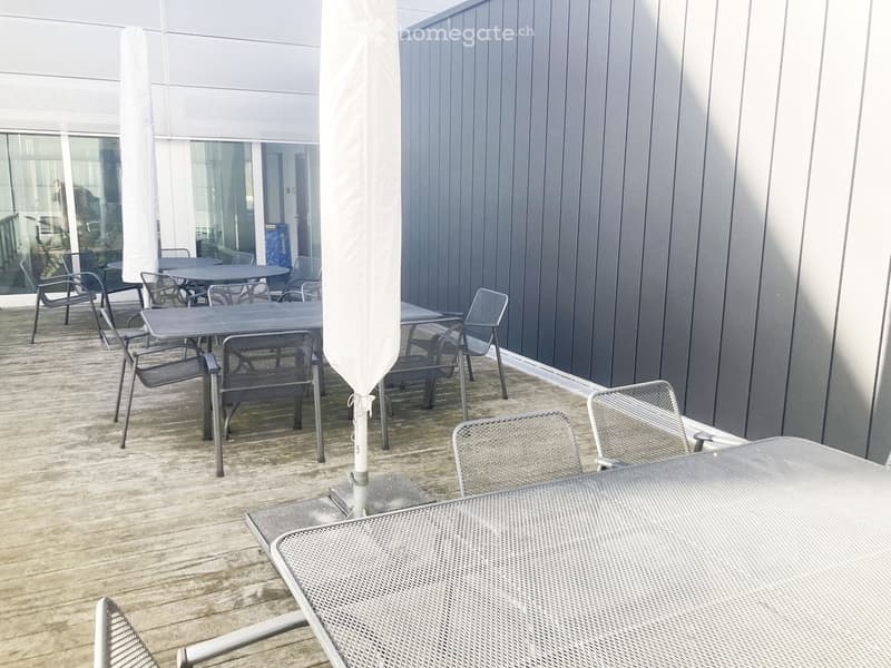 Outdoor dining area, wooden deck, metal tables and chairs, large open space