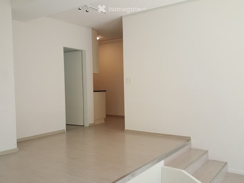 empty room, white walls, wooden floor, white door, stairs
