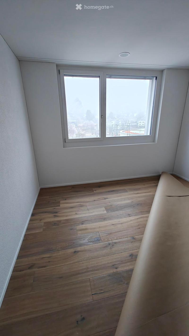 empty room, hardwood floor, white walls, window, roll of paper