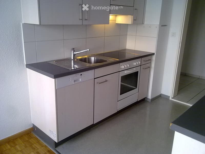 white cabinets, gray countertops, stainless steel sink, gas stove, oven, dishwasher, sink faucet