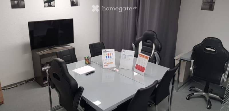 Conference room: desk, 6 chairs, television, table