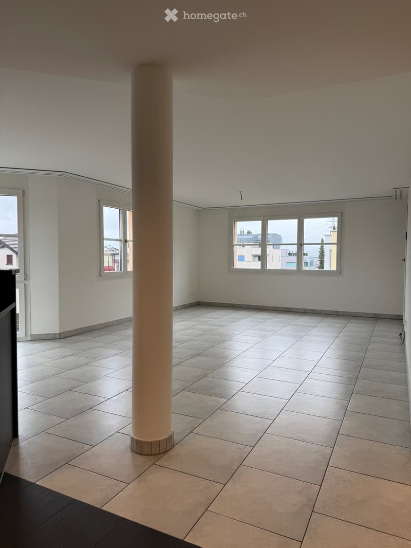 Unfurnished Room. Empty room with tiled floor, white walls, large windows, and a central column.