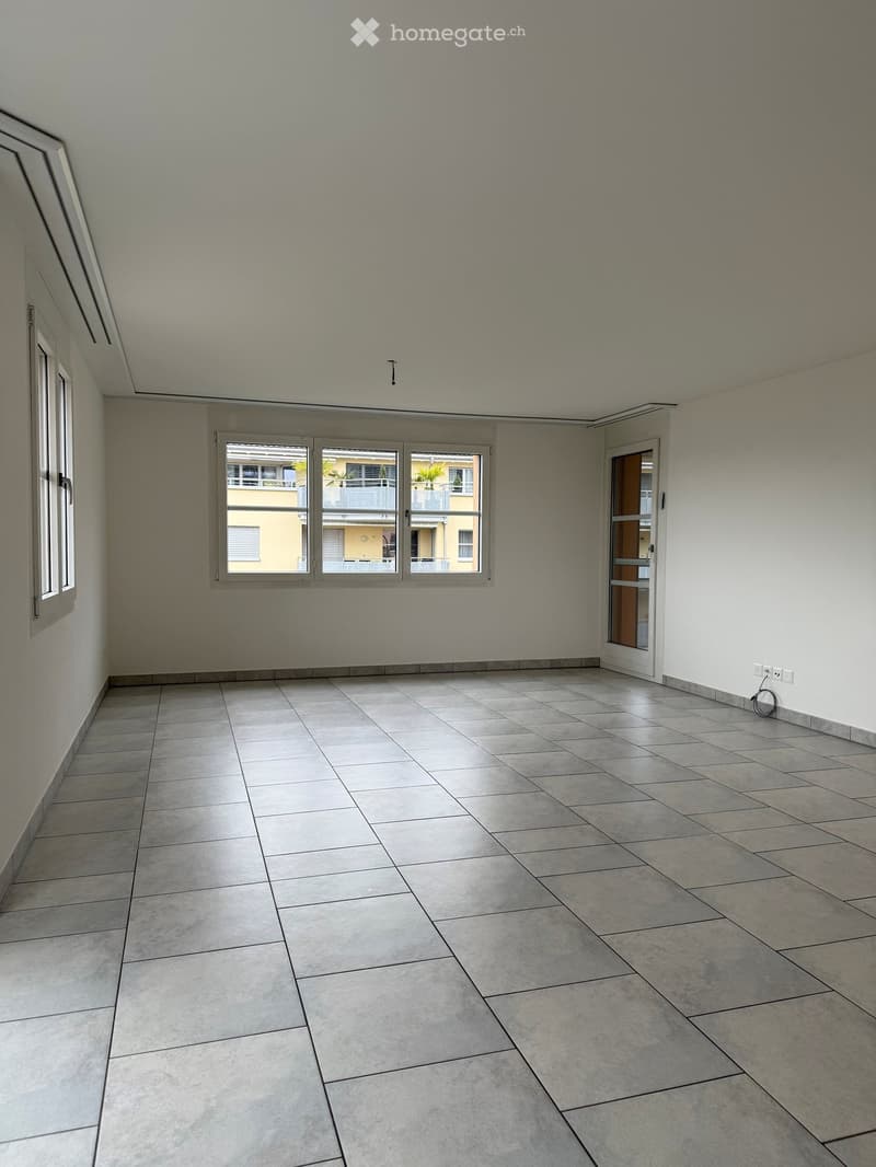Unfurnished Room. Empty room with tiled floor, large window, and door leading to another space.