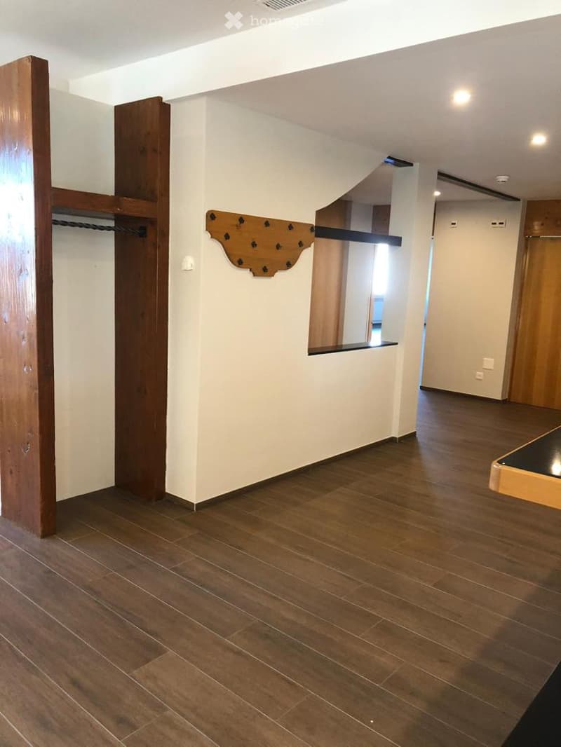 large wooden wardrobes, wooden floor, white walls, wooden window sill, corner window
