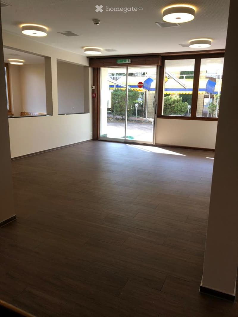 empty room, wood flooring, sliding doors, windows, recessed lighting