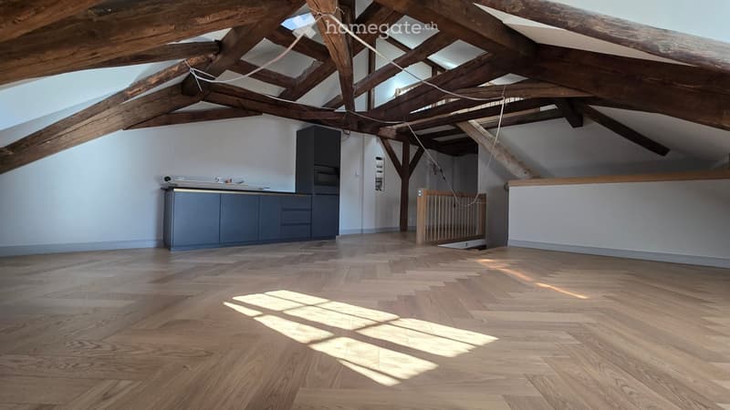 wooden beams, wooden floor, kitchen area with cabinets, wooden staircase