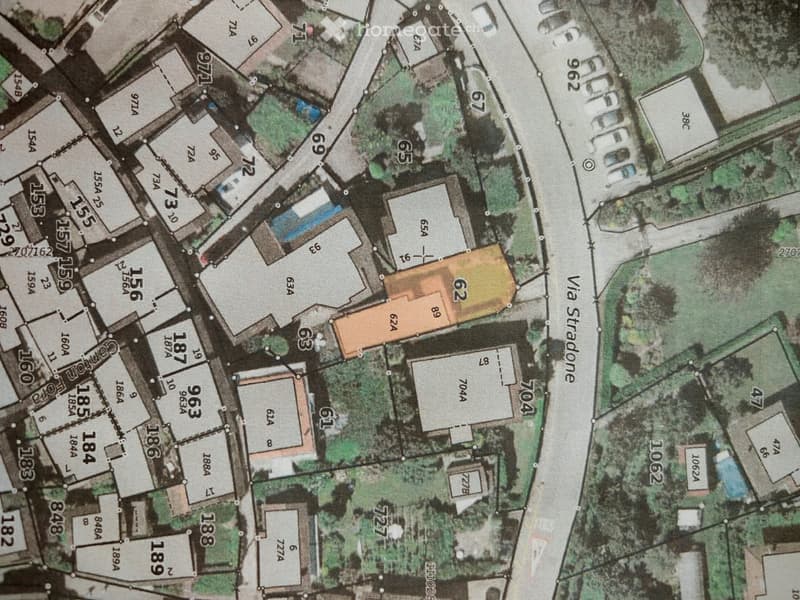 Various buildings and plots of land marked on the map, street names, building numbers, and plot numbers visible