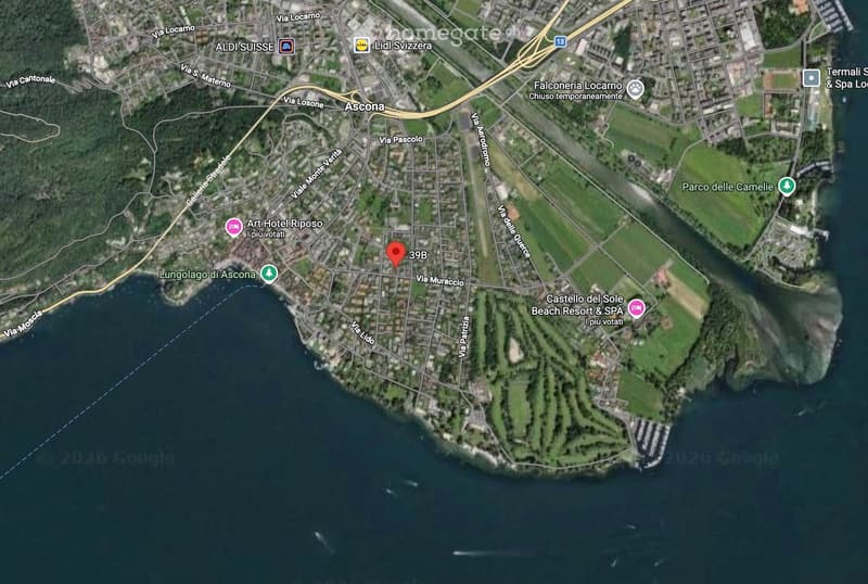 Aerial map of Ascona, showing roads, landmarks, and geographical features. Key landmarks include Art Hotel Riposo, Falconeria Locarno, and a water body. It highlights the location of Ascona and its surroundings.