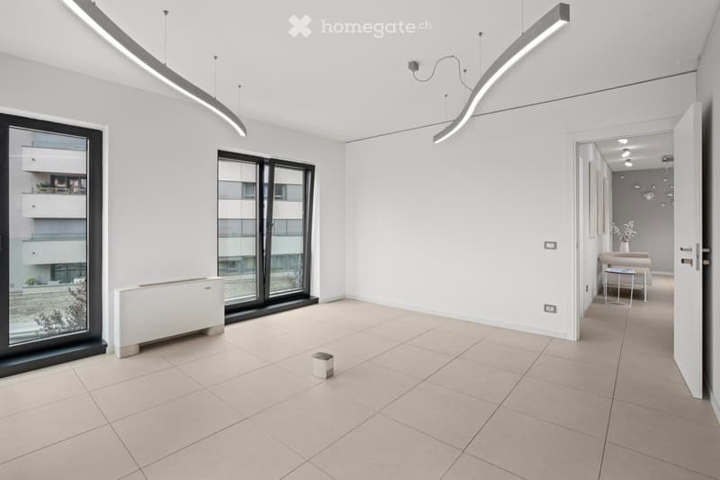 spacious, empty room with sliding doors to a balcony, modern lamps, square tiles, heaters under the window