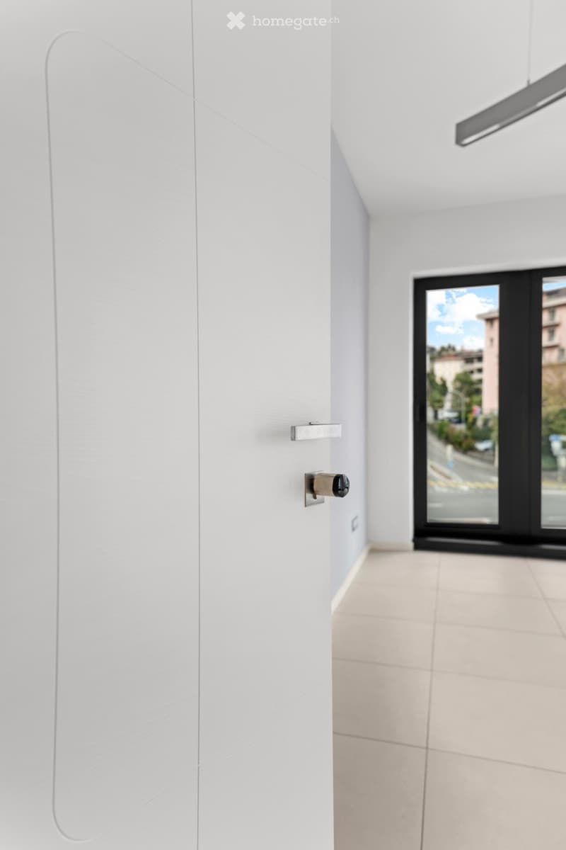 open door, tiled floor, double glass window, view of buildings and road