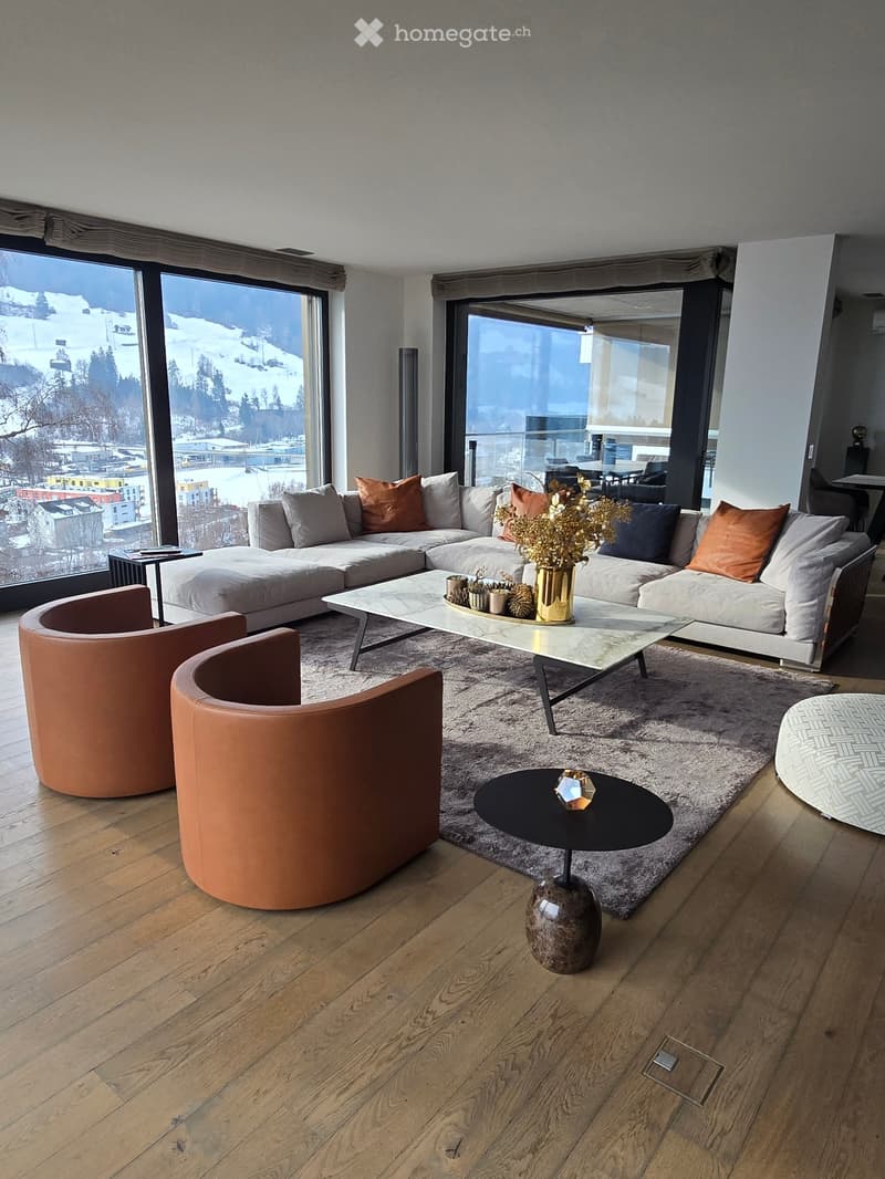 Open layout, couch, two side chairs, coffee table, decorative items, wood flooring