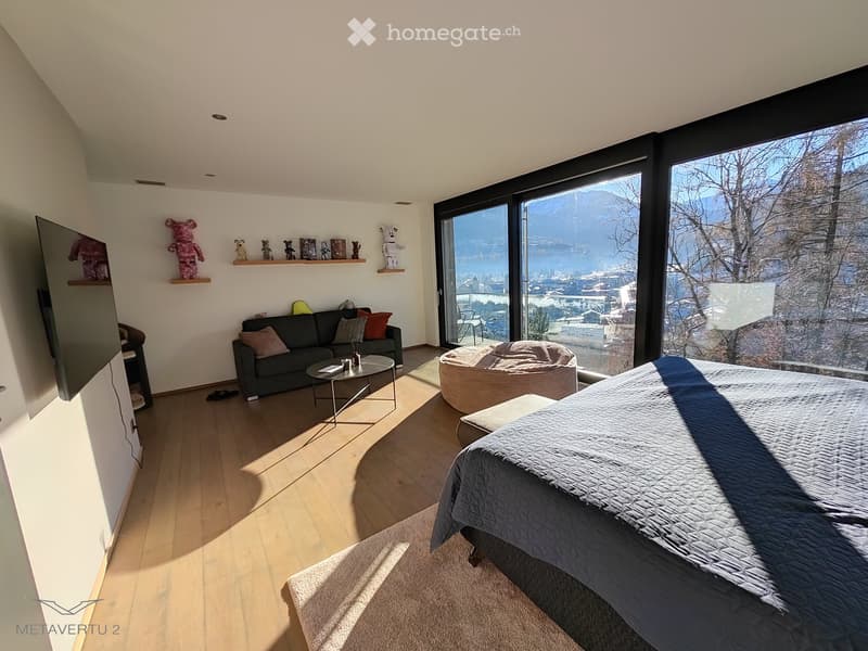 spacious room with large windows, modern decor, comfortable seating, wooden floors, scenic view