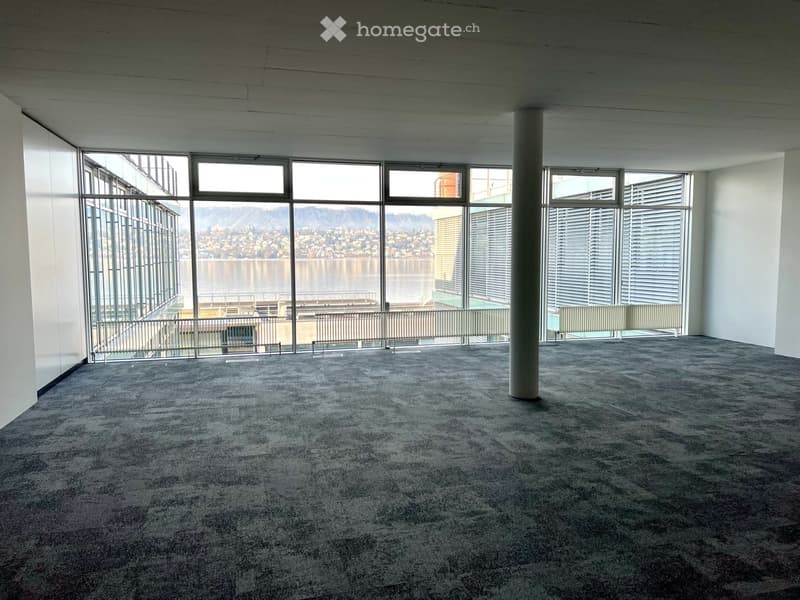 Empty room, large windows, balcony, tiled floor, pillar, city view