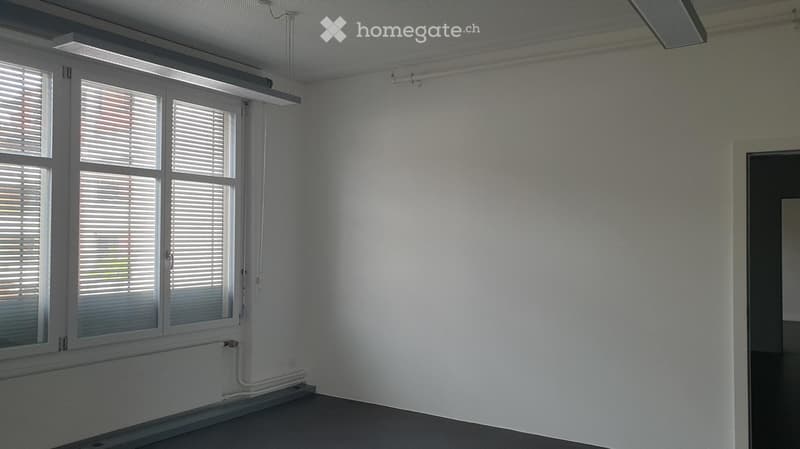 empty room with white walls, large window, radiator on the wall, large ceiling light