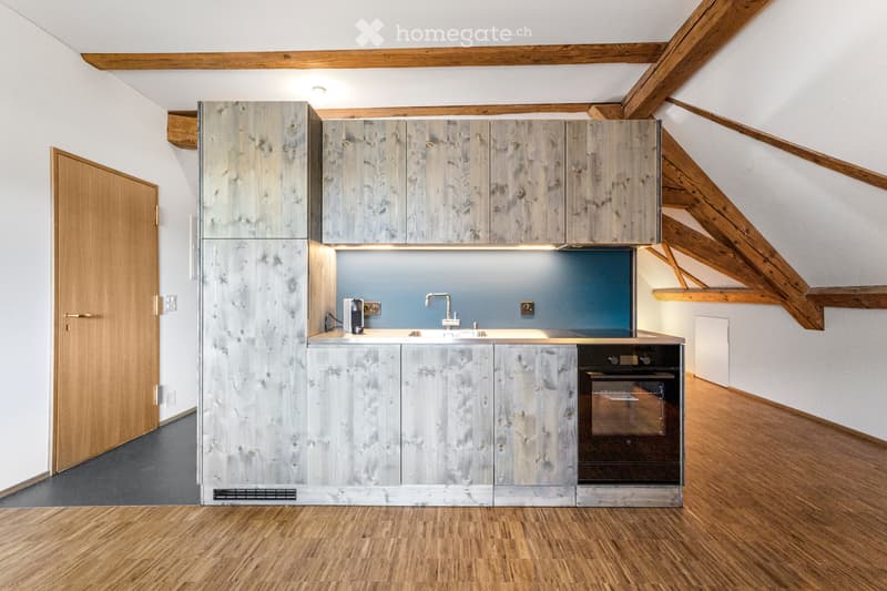 Wooden kitchen with wooden cabinets, wooden floor, wooden ceiling, and sink with faucet