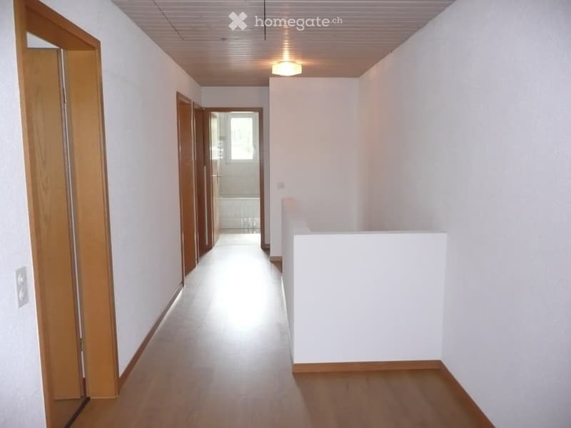 {"type": "Floor plan","description": "Corridor with hardwood flooring, white walls, a single ceiling light, and three doors leading to different rooms","localized_descriptions":    {    "EN": "Corridor with hardwood flooring, white walls, a single cei