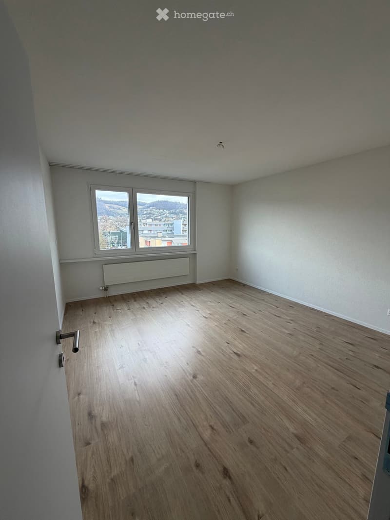 hardwood floor, white walls, window with view, heater