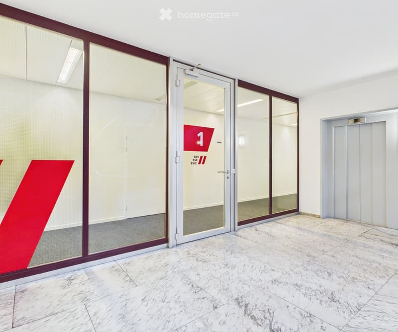 Marble floor, glass doors, elevator, red V sign