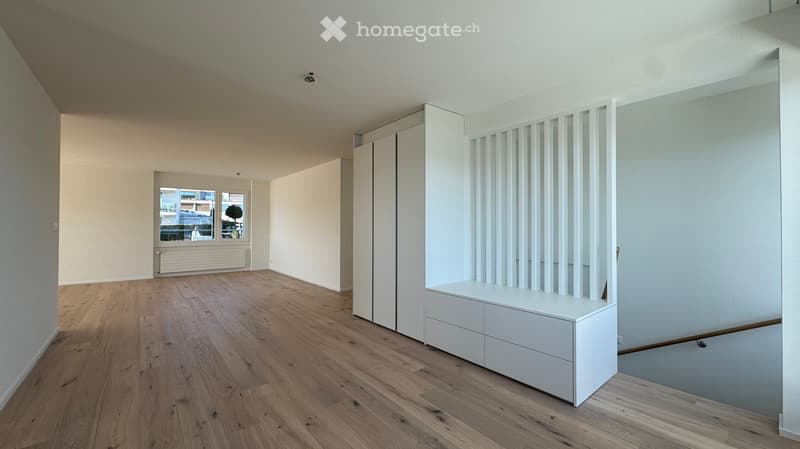 empty room, wooden floor, white walls, large window with view, built-in wardrobes, bench, staircase