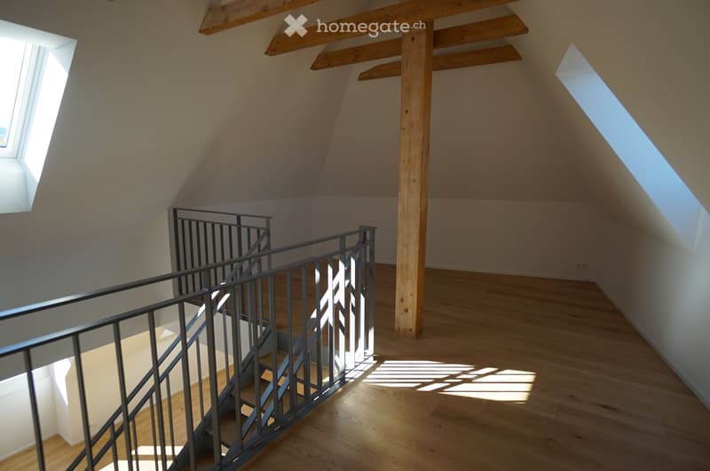 Attic, staircase, wooden beams, wooden floor, two skylights