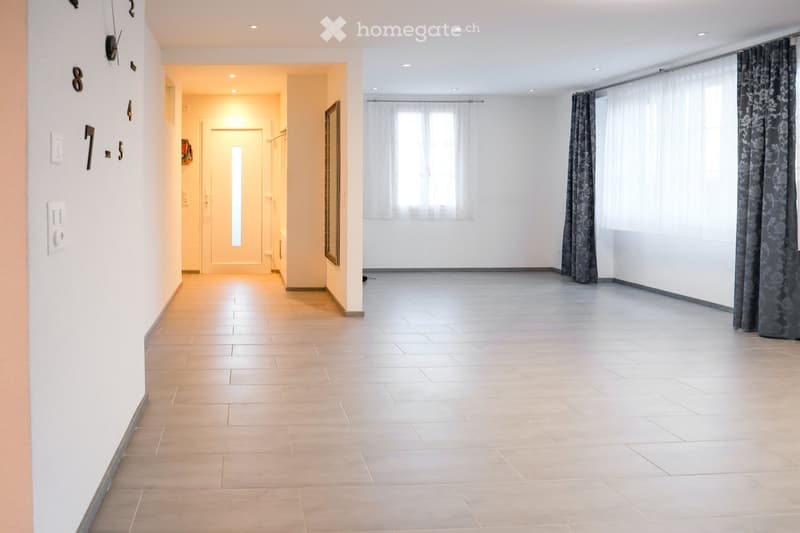 tiled flooring, white walls, doorway to another room, windows with white curtains