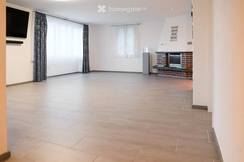 empty room, fireplace, large windows, tiled floor, mounted TV, speaker