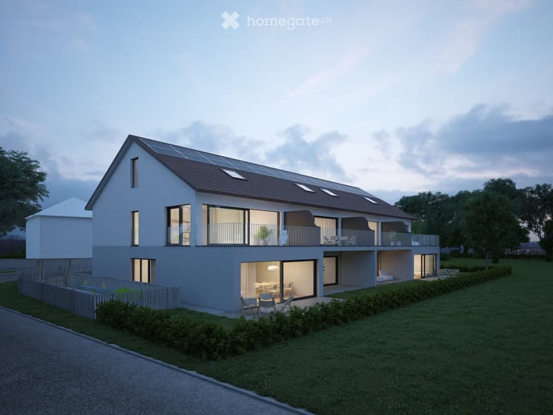 Detached two-story house, white exterior, solar panels on the roof, large windows, glass balcony, outdoor seating area, grassy lawn, fence, nearby trees