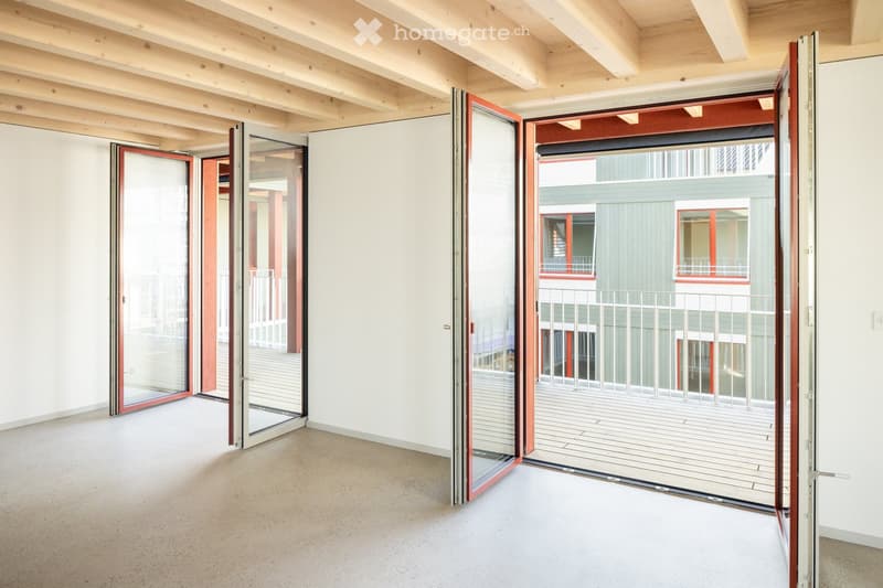 open doors leading to balcony, wooden ceiling